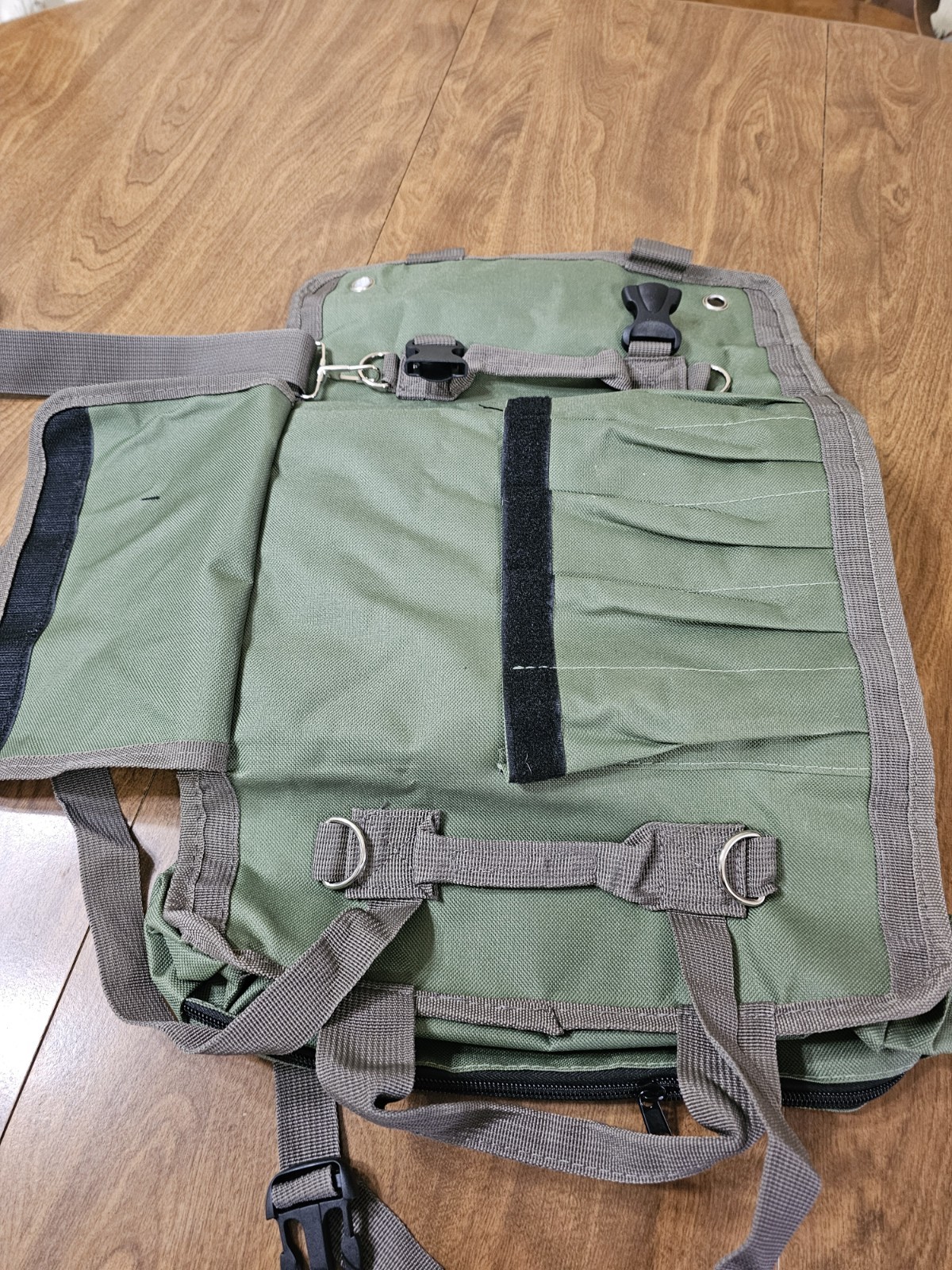 Tool Bag With 7 Pockets Olive green with straps and shoulder strap.