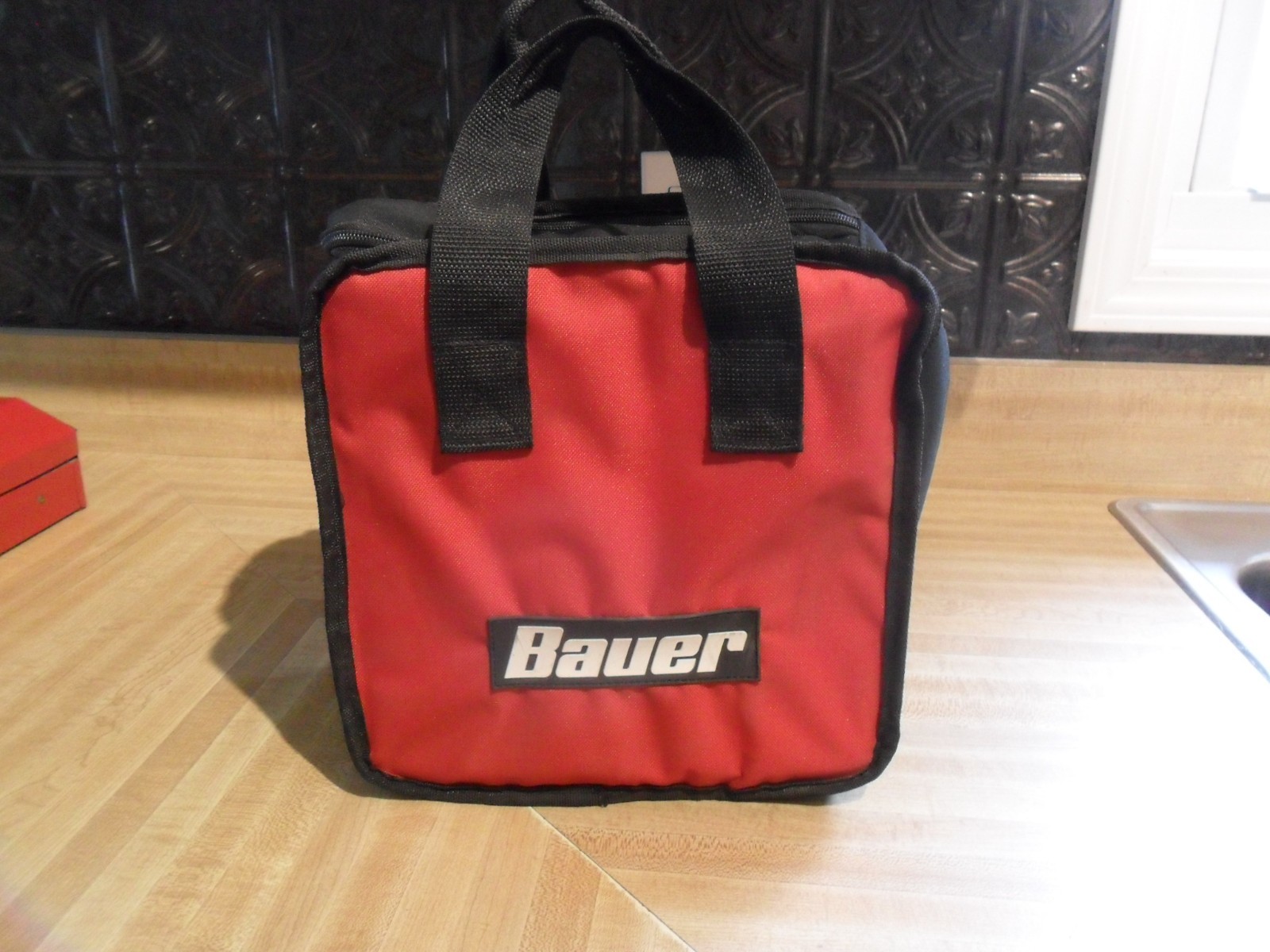 BAUER RED AND BLACK TWO HANDLE TOOL BAG.