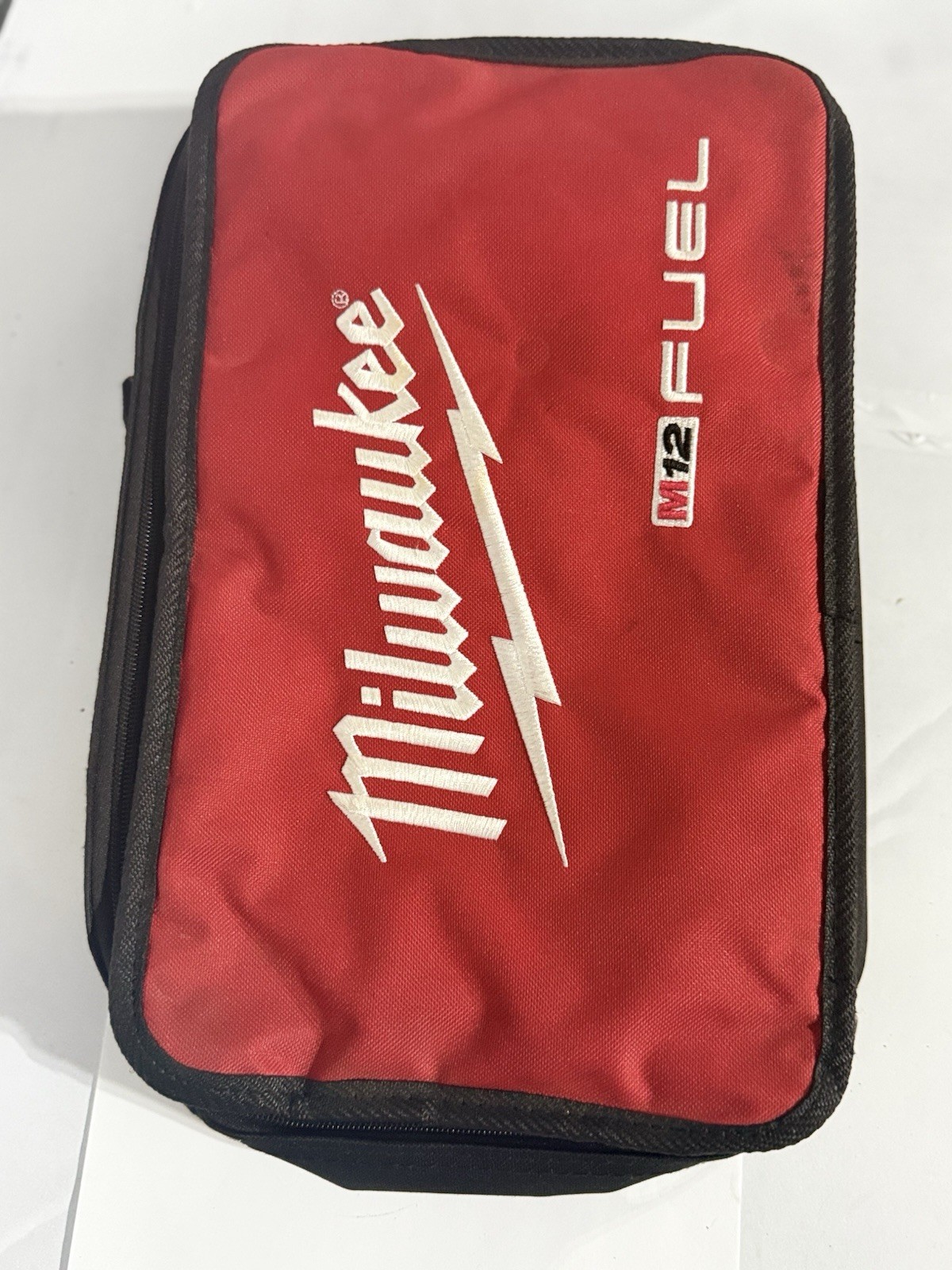 Milwaukee M12 Fuel Zippered Fabric Tool Bag w/ M12 charger and carrying bag.